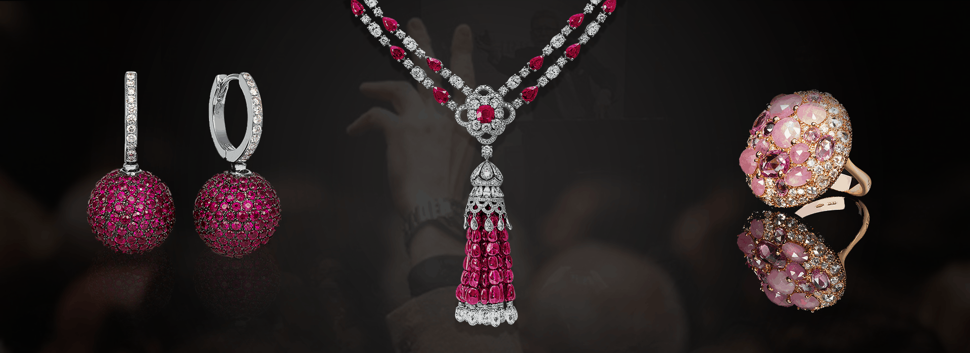 High-end designer jewelry including ruby tassel necklaces and gemstone-encrusted rings for auction assessment.